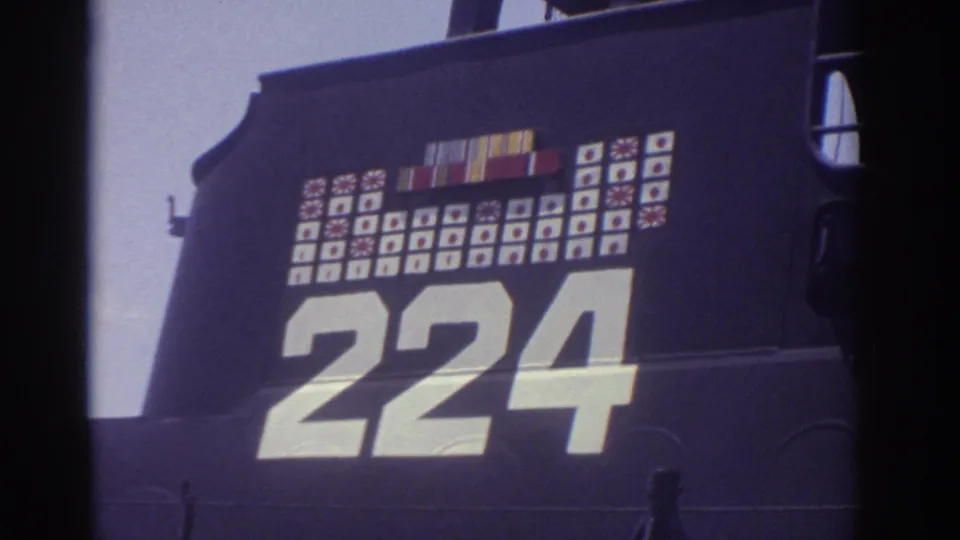 Close 1974 Cleveland home-movie view of the submarine's dark hull, large 224 numerals, and painted service-style markings.