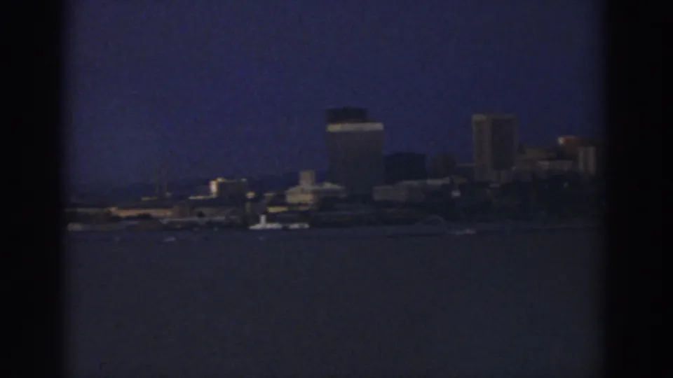 Distant Cleveland buildings and shoreline remain visible across dark water in the final 1974 8mm frame.