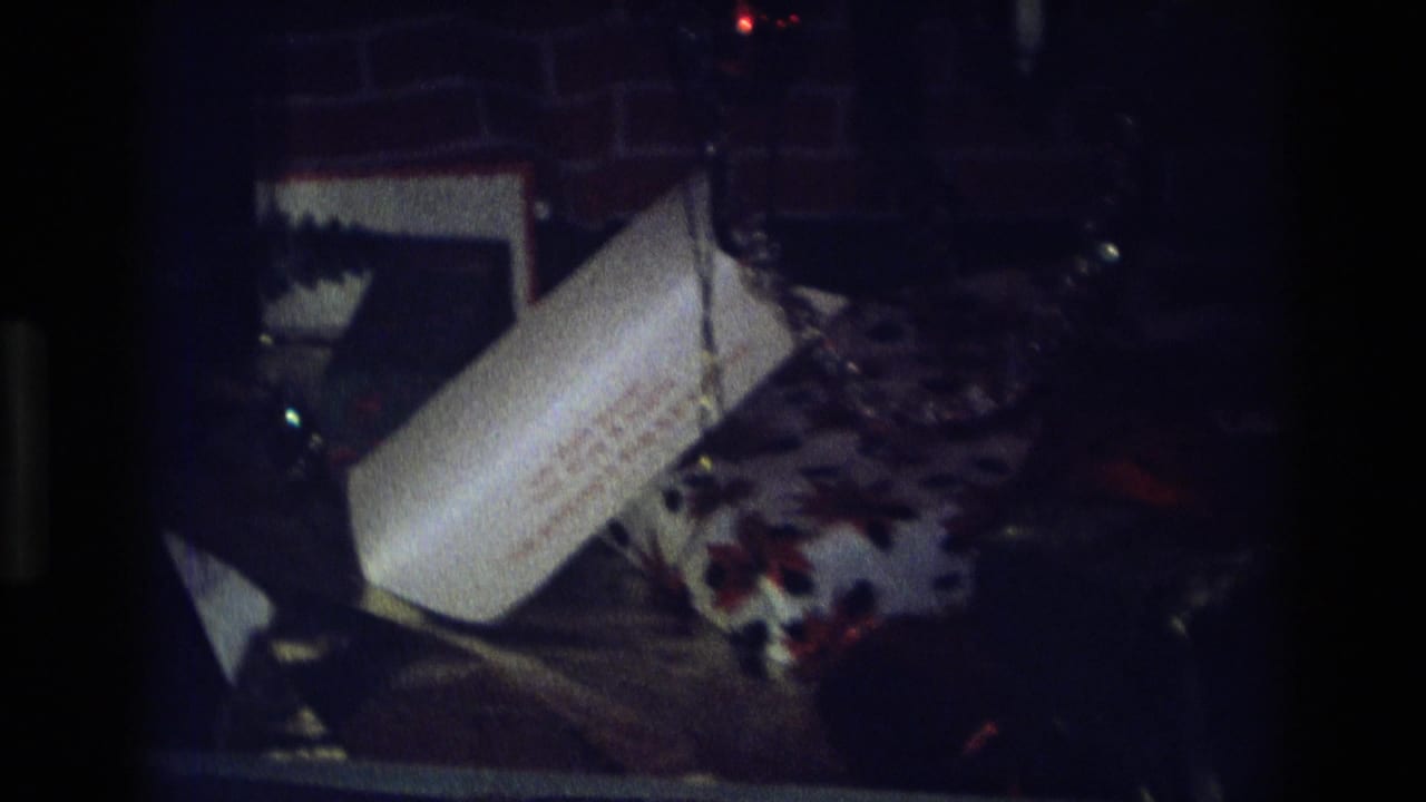 White plastic bag and patterned fabric in a dim cluttered interior.