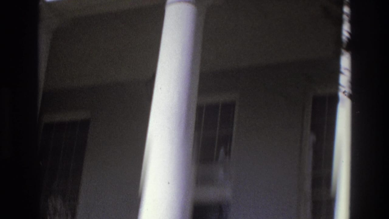 1975 Atlanta 8mm frame showing a white-columned building exterior with windows and deep shadow.