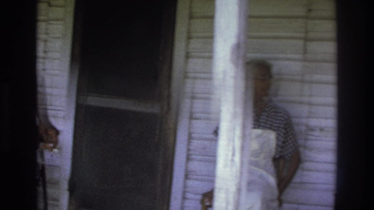 Porch doorway and white siding with a partially visible person at the edge.