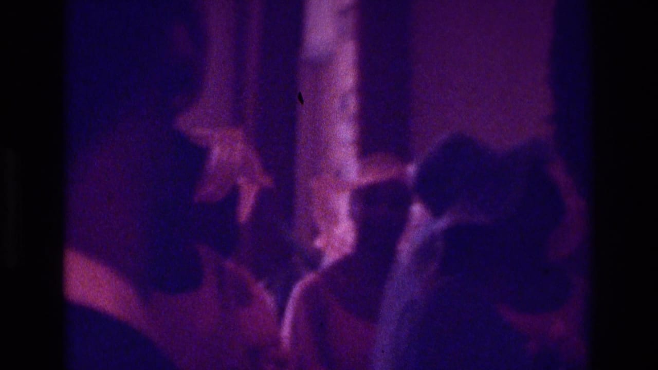 Dim Atlanta 1975 religious-event frame with silhouetted attendees and a robed figure partly visible near the ceremony area.