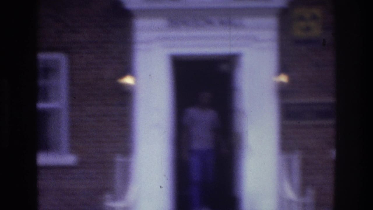 In 1975 Atlanta home-movie footage, a teenager appears in the doorway of a brick building framed by white columns.