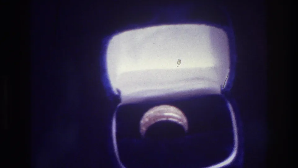 1975 Bronx 8mm close-up of a ring nestled in an open jewelry box, with bright lining and deep blue shadows.