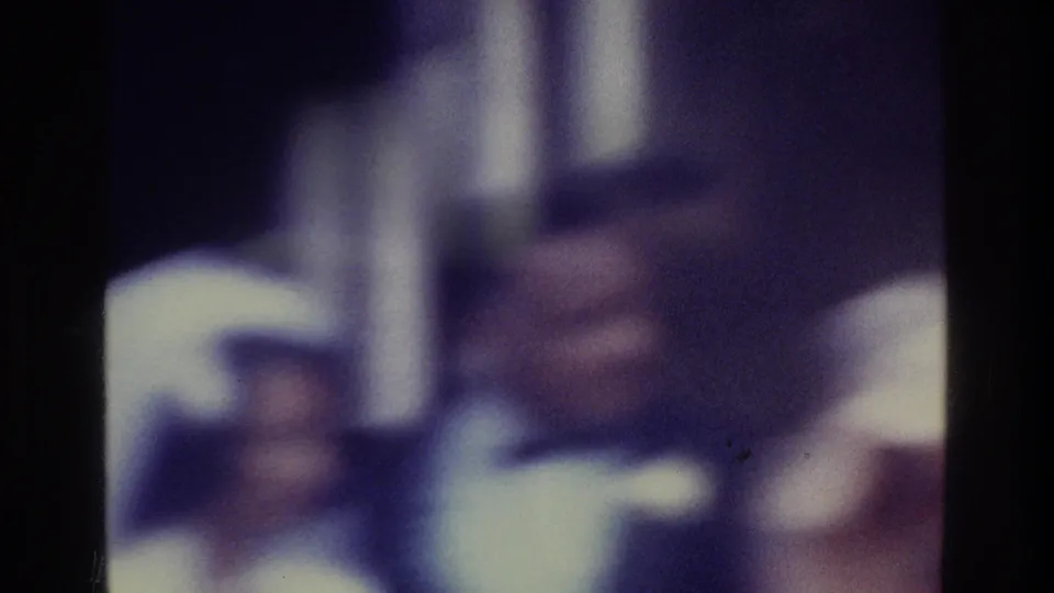 1975 Bronx wedding frame with the groom prominent in a tuxedo and the bride partly visible beside him.