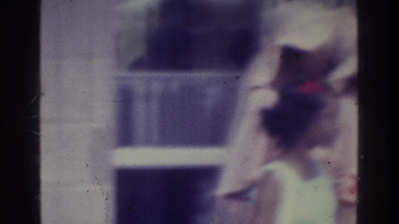 Soft 8mm frame of a bride in white near a church aisle with a dark-suited figure nearby.
