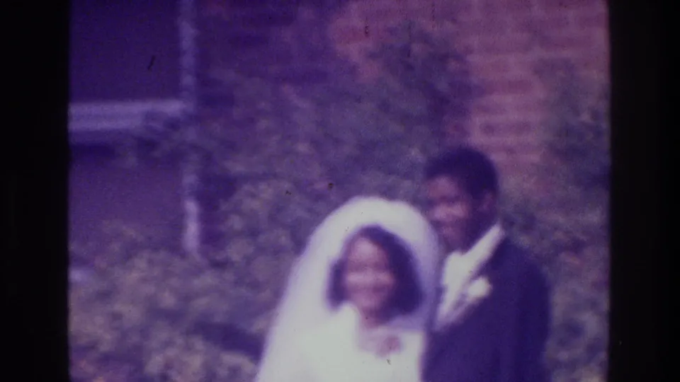The final frame keeps the wedding couple centered in soft 8mm focus, with Bronx 1975 metadata supporting the setting.