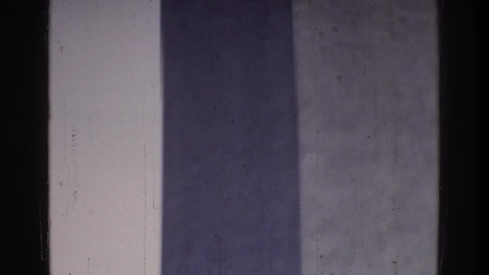 Extreme close-up of the Washington Monument obelisk shaft in 8mm home movie footage circa 1975, Washington DC, with pale sky at frame edge