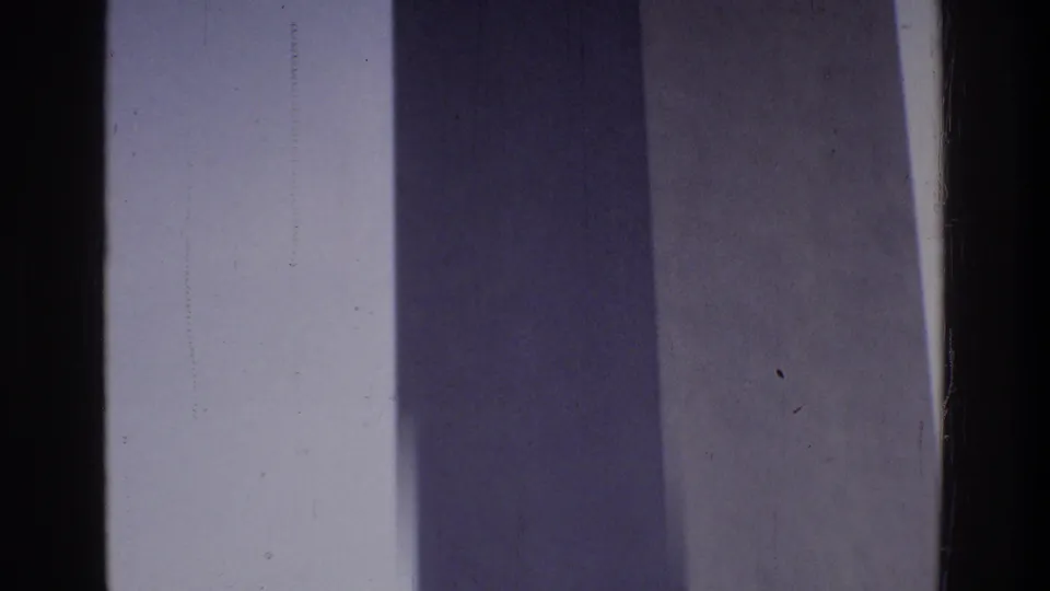 Mid-shaft view of the Washington Monument in 8mm home movie footage circa 1975, Washington DC, showing light and blue-gray shadow on the obelisk surface