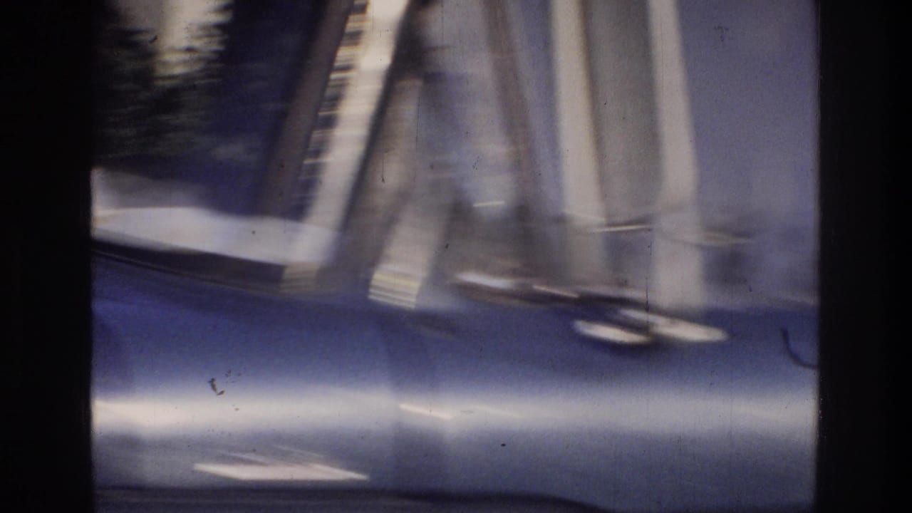 Extreme close-up of a blue truck body panel on 8mm home movie film, Washington DC area, circa 1975, detail obscured by heavy motion blur.