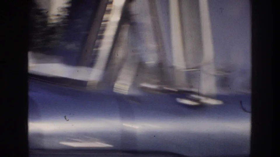Extreme close-up of a blue truck body panel on 8mm home movie film, Washington DC area, circa 1975, detail obscured by heavy motion blur.