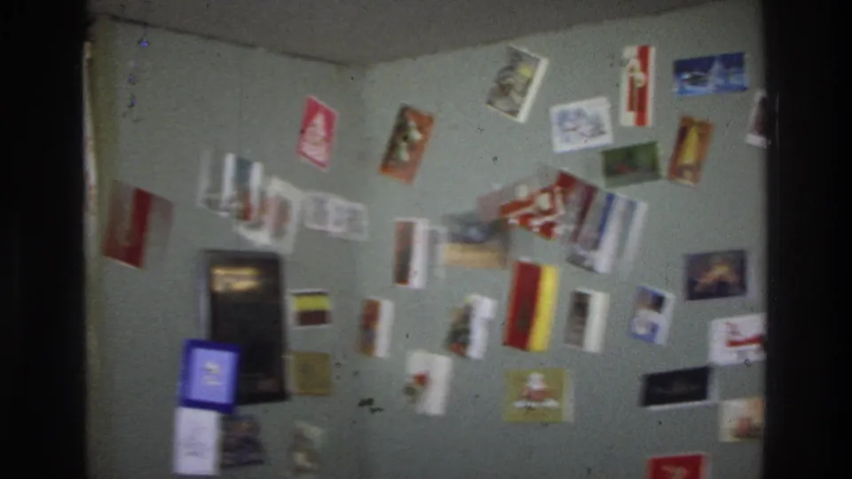 Colorful Christmas cards displayed across two walls in a room corner; a common mid-1970s American domestic practice; Washington DC home, circa 1975.