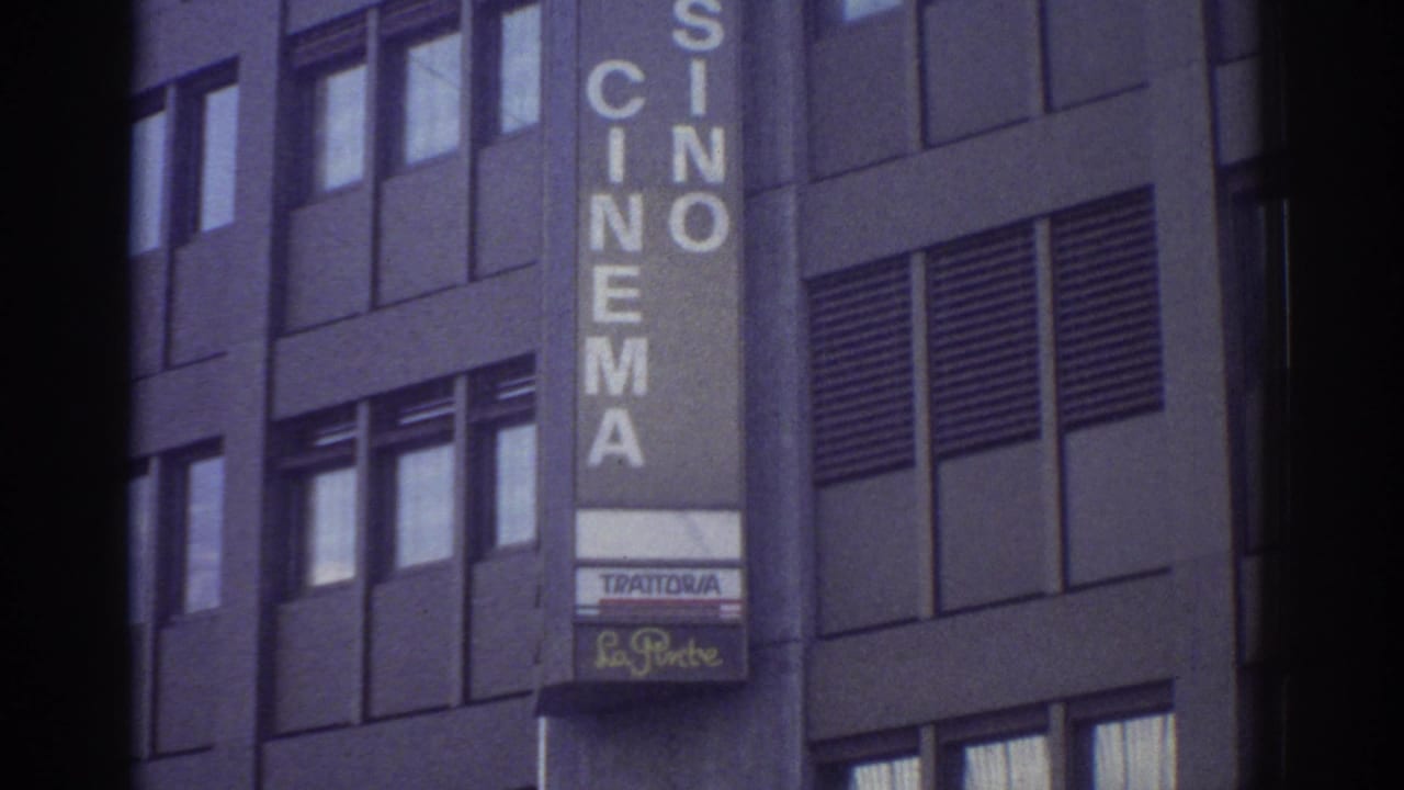 Mid-section of HOTEL CASINO CINEMA sign with Trattoria restaurant sign below on a modernist building facade, Bern, Switzerland, circa 1976, 8mm film.