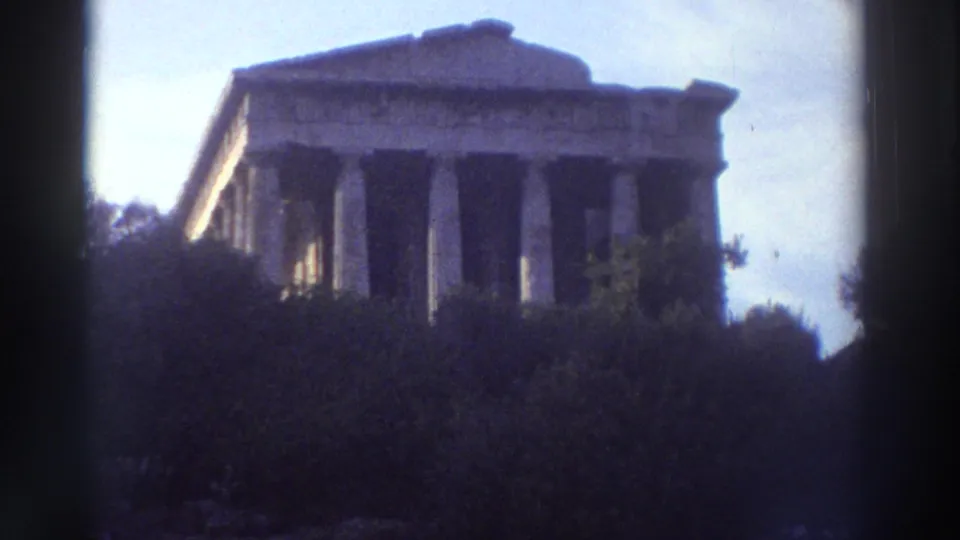 Doric temple colonnade in Greece with scrub vegetation foreground, 8mm home movie footage circa 1976