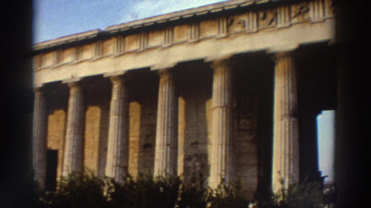 Closer side view of the Temple of Hephaestus colonnade, Athens, c. 1976, showing fluted Doric shafts and stone entablature in warm light.