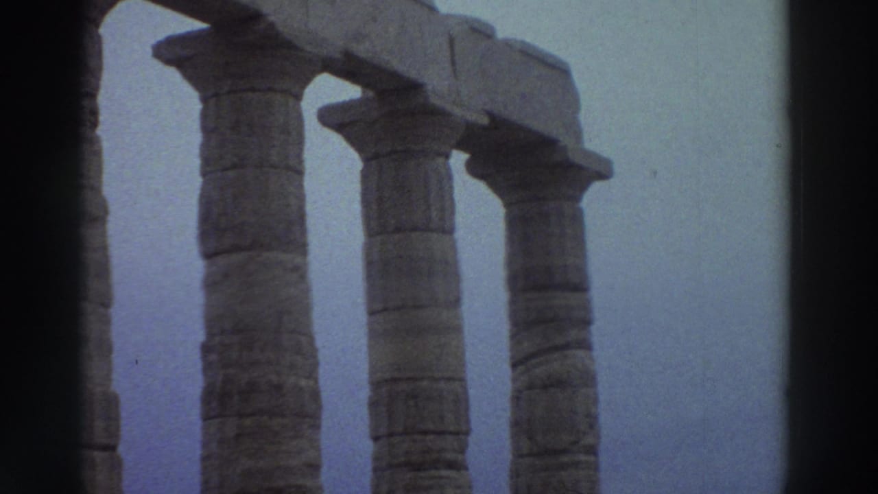 Three Doric-style stone columns from ancient Greek temple ruins filmed on 8mm in Greece circa 1976, with characteristic blue color drift.