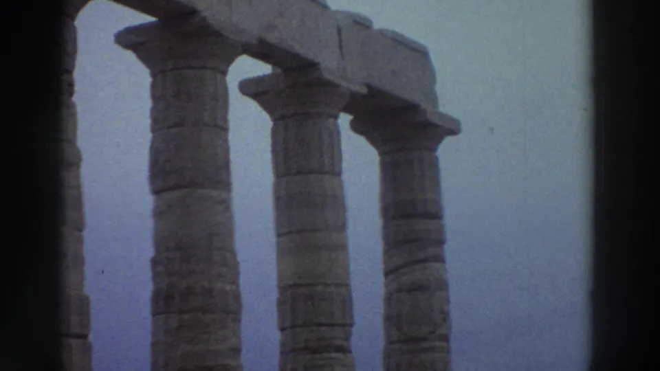 Three Doric-style stone columns from ancient Greek temple ruins filmed on 8mm in Greece circa 1976, with characteristic blue color drift.