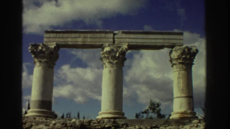 Corinthian-order columns with carved capitals and partial entablature at ancient ruins in Greece circa 1976, static Super 8 shot near clip end.