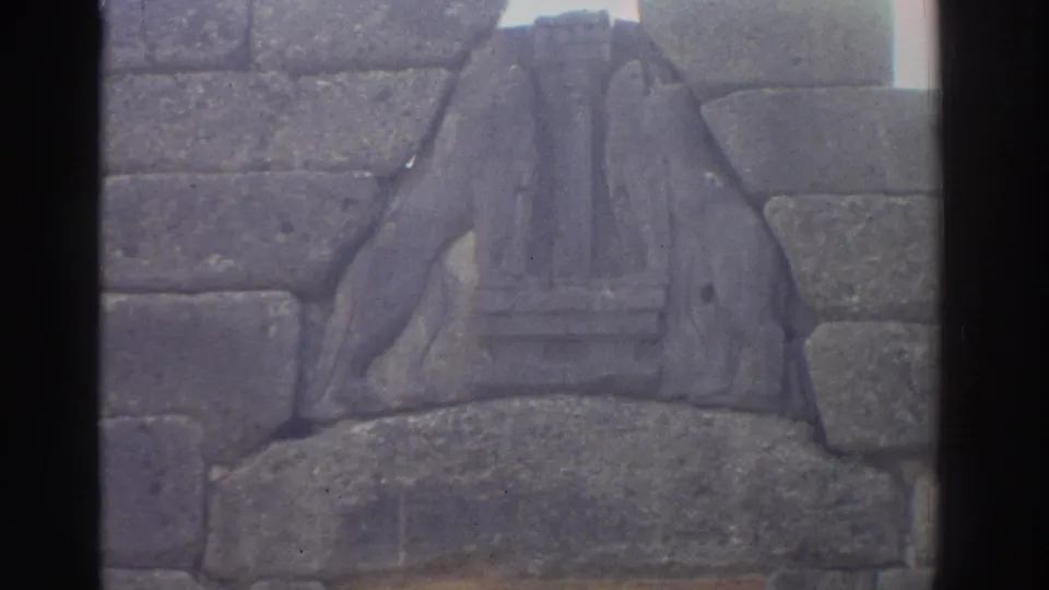 8mm footage of the Lion Gate relief at Mycenae, Greece, c.1976; nearly identical framing to the preceding shot with slight handheld drift.
