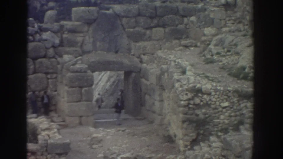 8mm footage of a large fitted-stone archway with cyclopean masonry at an ancient Greek archaeological site, visitors visible, Greece, 1976