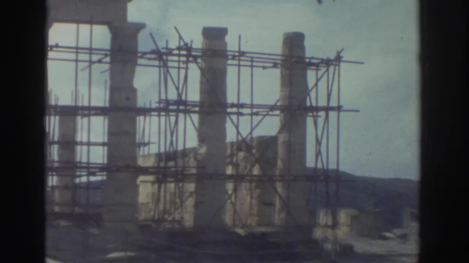 A second view of Greek stone ruins with scaffolding, framed by the dark edge of the 8mm contact-sheet scan.