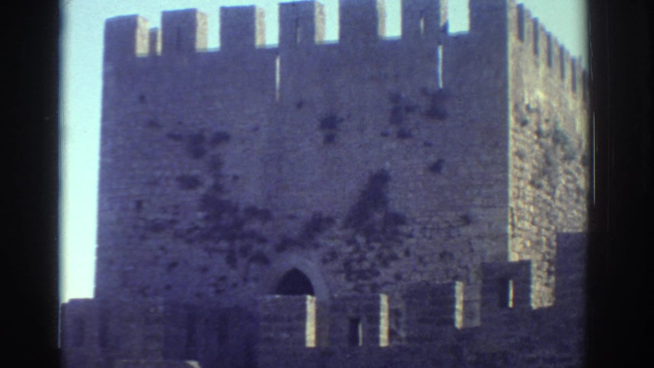 Stone battlements and arched opening on a castle-like wall.