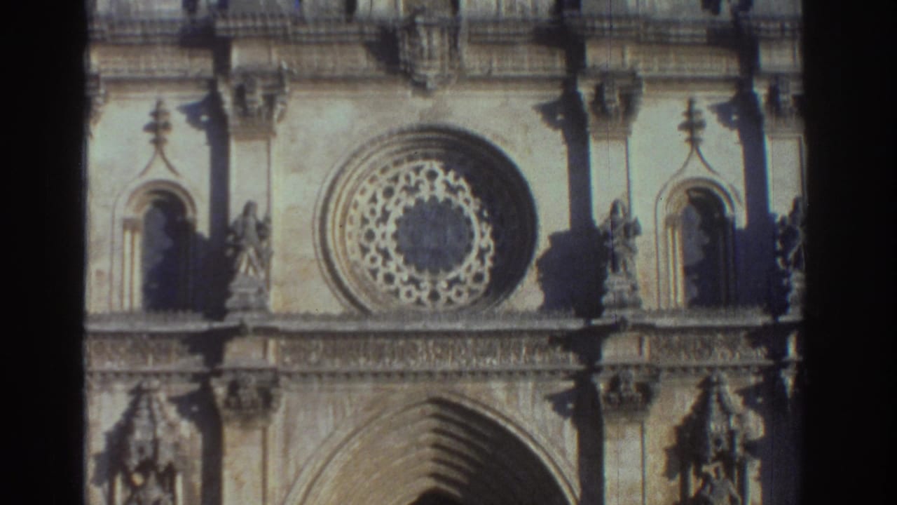 Cathedral facade detail with rose window above a pointed arch.
