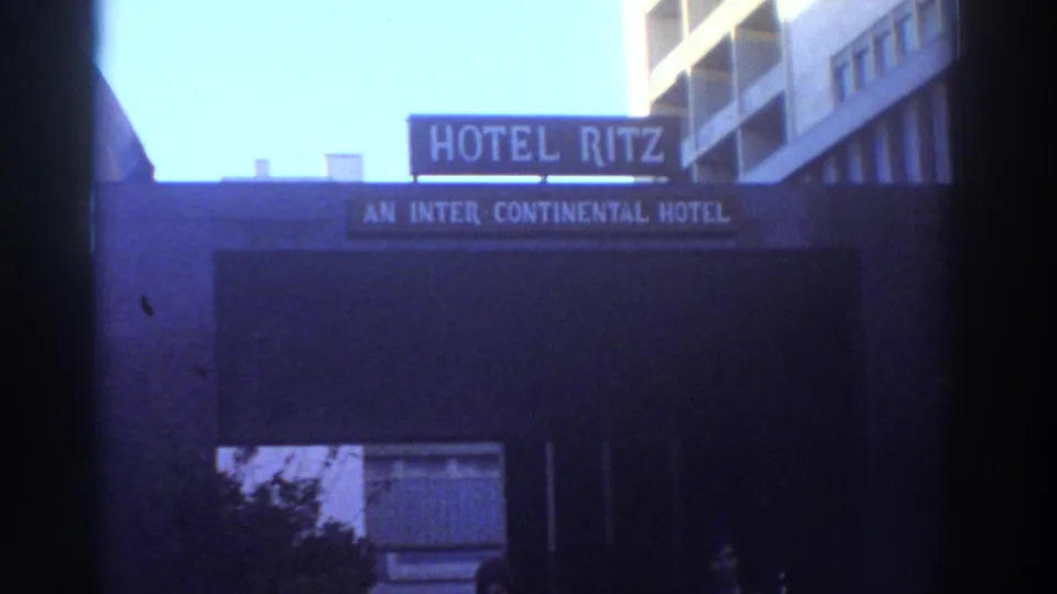 1976 Greece 8mm frame showing the Hotel Ritz sign, Inter-Continental wording, dark entrance, and small figures near the lower edge.