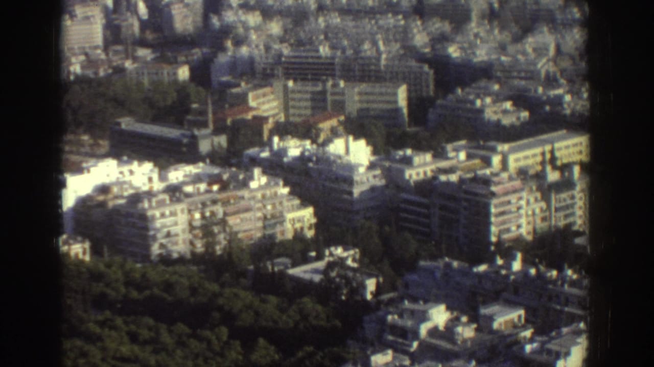 Elevated 1976 Tel Aviv view with apartment blocks, flat roofs, roads, and a green strip in the foreground.