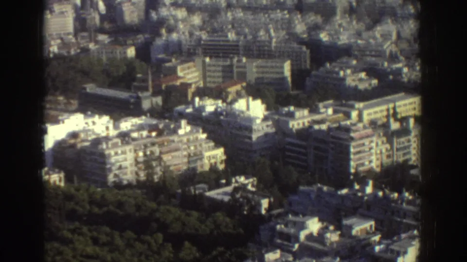 Elevated 1976 Tel Aviv view with apartment blocks, flat roofs, roads, and a green strip in the foreground.