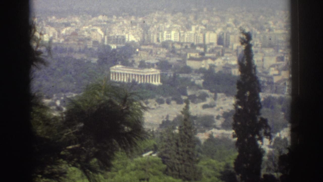 Similar city overlook with trees and a columned structure in the distance.