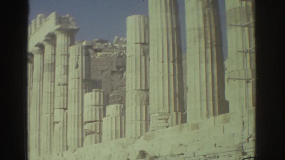 1976 Tel Aviv archival frame with tall pale columns, scaffold sections and eroded stonework in bright daylight.