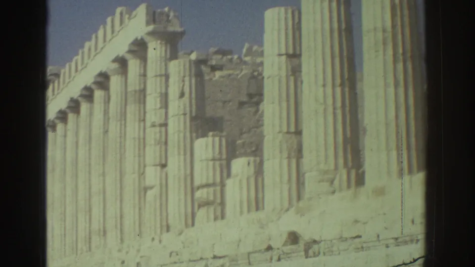 1976 Tel Aviv home-movie frame looking along pale classical-style columns and weathered stone remains.