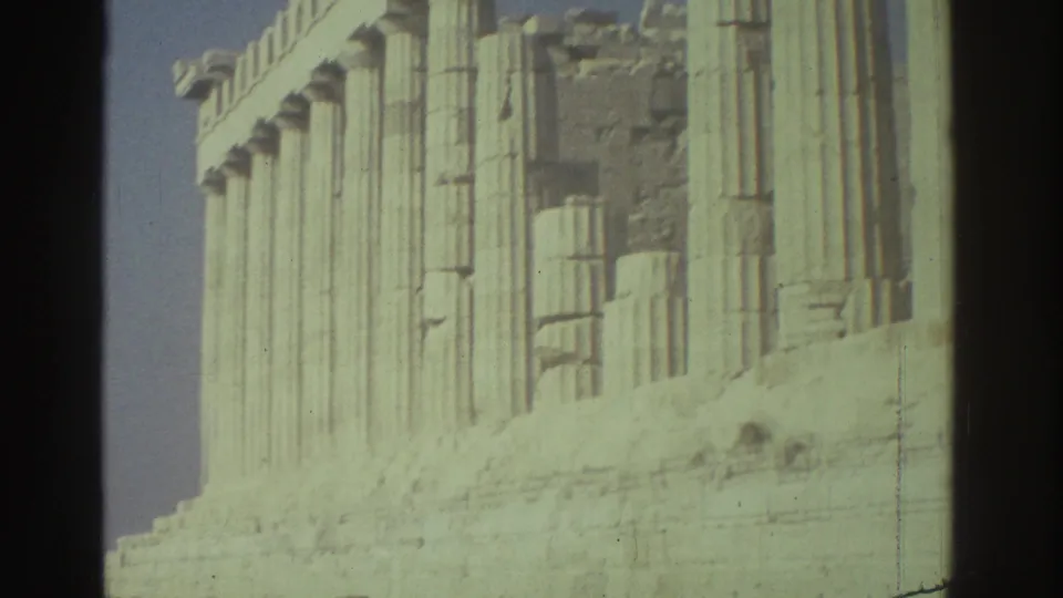 1976 Tel Aviv frame showing close architectural detail of pale columns, stone blocks and a scaffold edge.