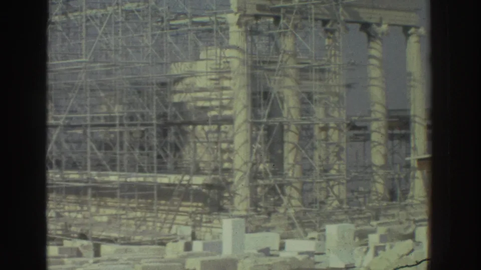 Cataloged 1976 8mm travel frame showing scaffolded classical columns, restoration framework, pale stone blocks, and soft handheld framing.