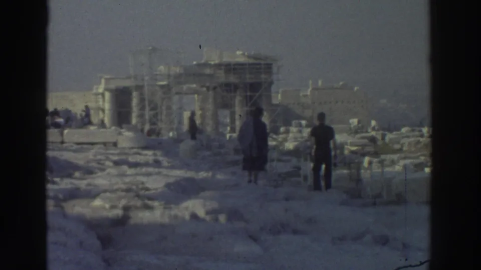 1970s 8mm travel footage shows visitors walking among stone blocks toward a scaffolded ancient monument.