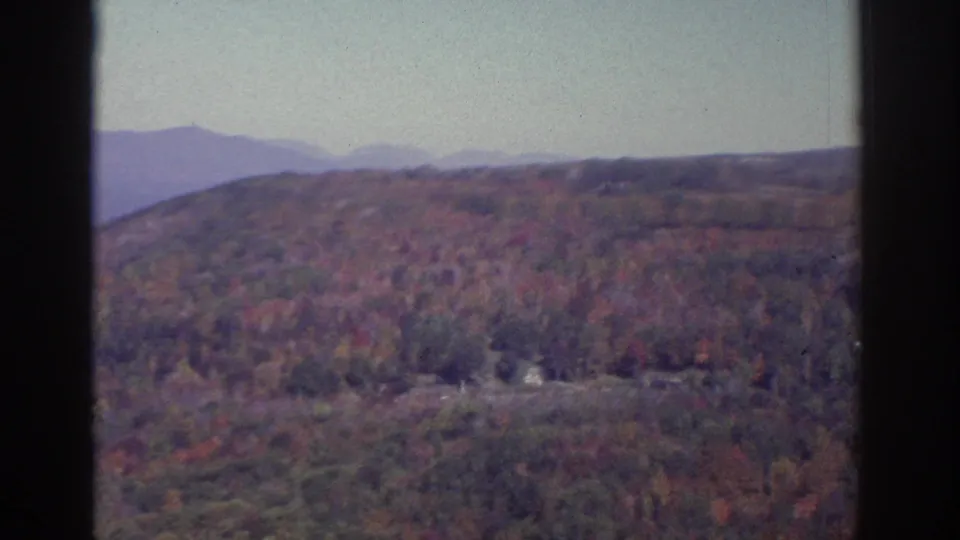 Watkins Glen-area autumn panorama on 8mm film, showing wooded hills, muted fall color, and distant ridgelines.