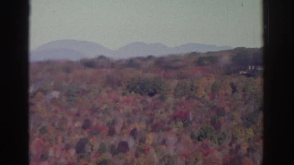 Watkins Glen-area 8mm view of an autumn valley with distant rounded hills, muted colors, and dark frame borders.