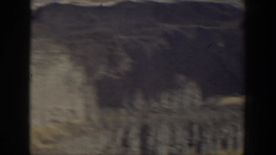 Soft 8mm view of rugged layered rock formations, likely part of the California landscape sequence.