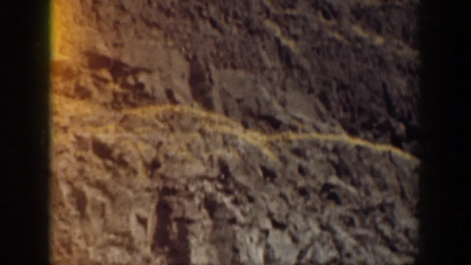 Warm exposed rock and cliff texture in a California waterfront scene, filmed as a brief home-movie landscape detail.