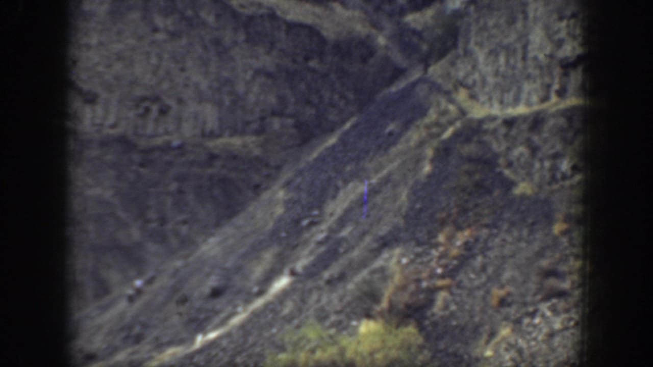 1937 California 8mm frame showing a rugged rocky slope and dry ground with no clear people visible.