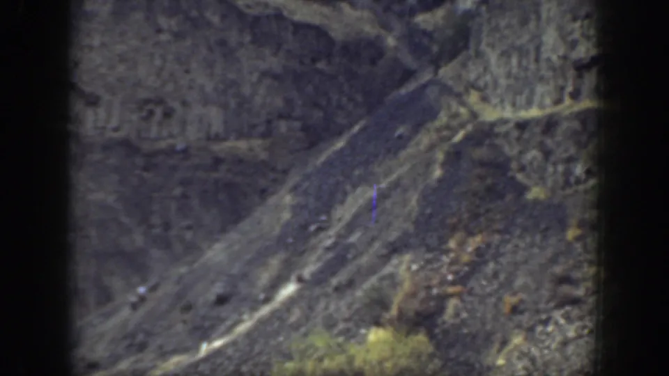 1937 California 8mm frame showing a rugged rocky slope and dry ground with no clear people visible.