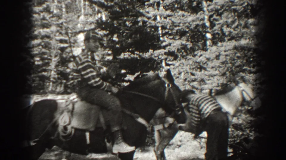 1938 California frame with a striped-shirt rider on horseback in a wooded area, with another horse partly visible.