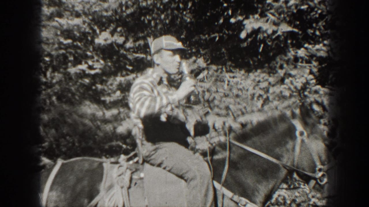 Man on horseback holds a bottle near his mouth as trees fill the background.