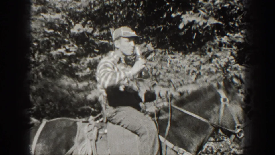 A young man on horseback holds a bottle near his mouth in a wooded California setting, shown in grainy 1938 8mm footage.