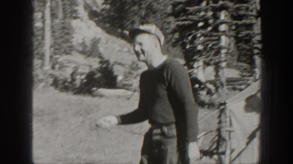 A young man stands near a horse along a wooded path or roadside in California, recorded in 1938 home-movie footage.