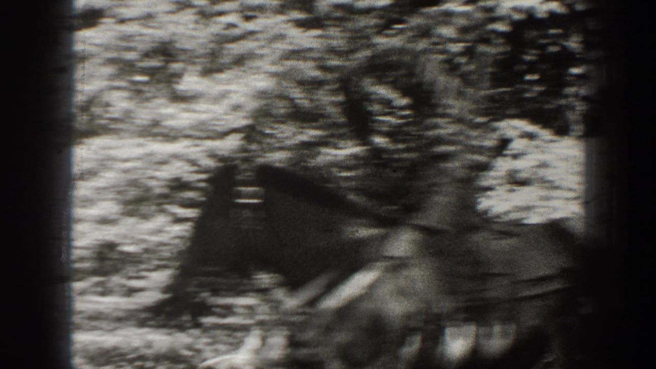 1938 California 8mm frame showing a blurred rider on a saddled horse among trees and rough ground.
