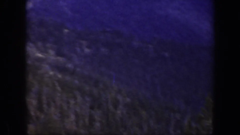 Soft 1938 California mountain frame showing forested slopes and evergreens with heavy purple color shift.