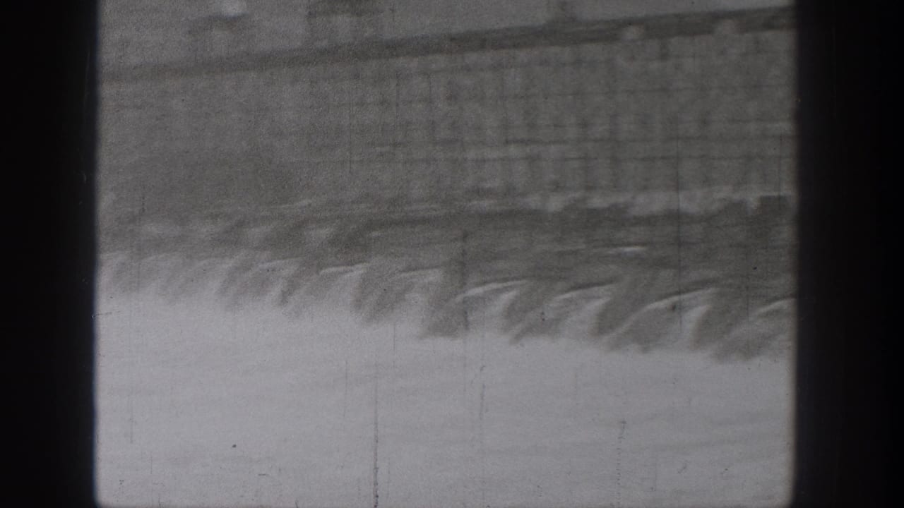Water and bridge structure with a dark vertical band through the center of the frame.