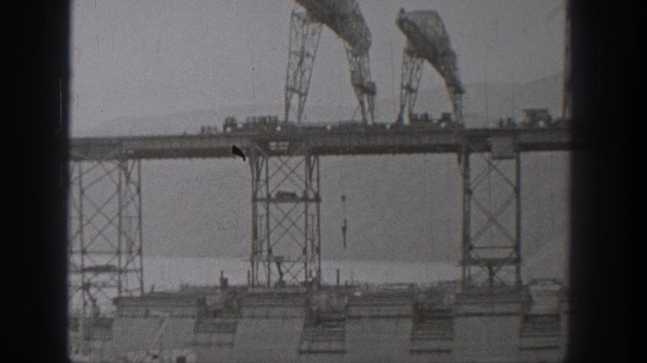 Washington 1938 home-movie frame with gantry towers and crane-like equipment viewed from a static distance.